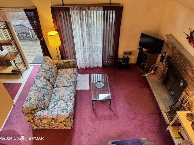 carpeted living room featuring a fireplace and visible vents