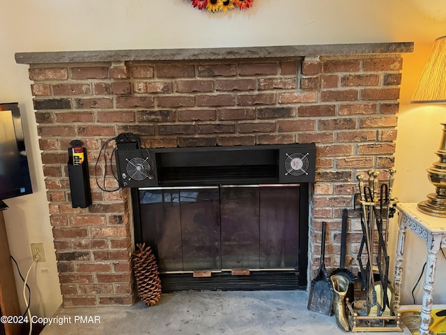 room details with a fireplace and unfinished concrete floors