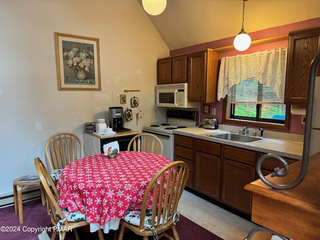 kitchen with white appliances, vaulted ceiling, light countertops, pendant lighting, and a sink