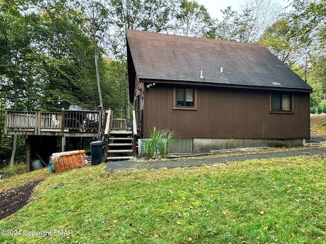 view of side of home featuring crawl space, a yard, a shingled roof, and a wooden deck