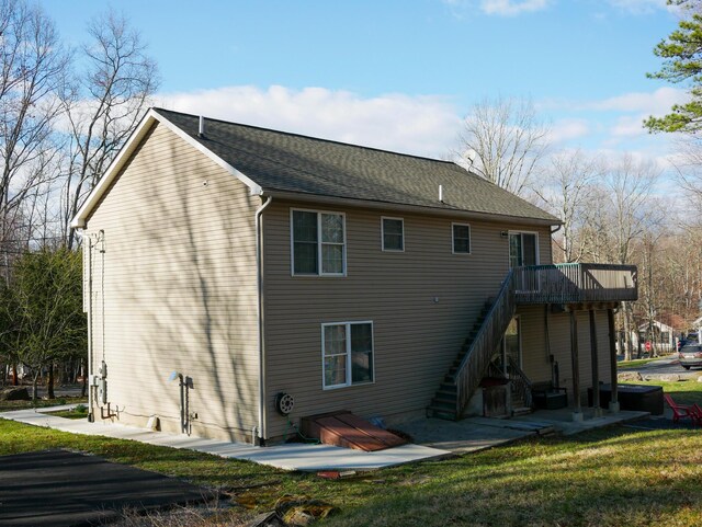5109 Hickory Ln, East Stroudsburg, PA 18302 - back of house featuring a wooden deck, roof with shingles, stairs, and a lawn