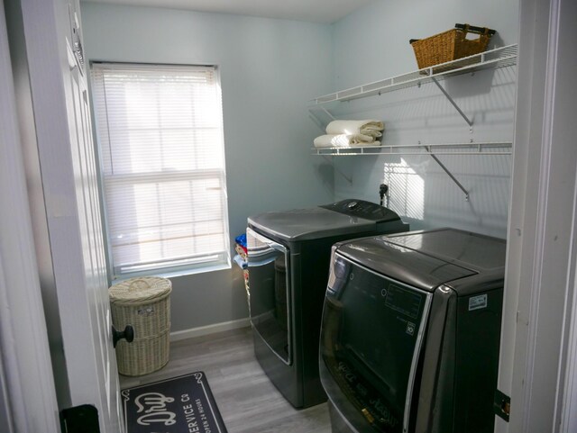 5109 Hickory Ln, East Stroudsburg, PA 18302 - laundry area featuring washing machine and dryer, a healthy amount of sunlight, baseboards, and laundry area