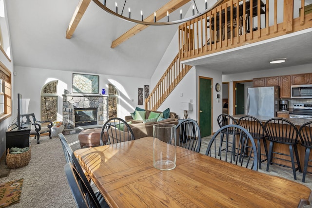 225 N Arrow Dr, Pocono Lake, PA 18347 - dining room featuring stairway, high vaulted ceiling, carpet flooring, a stone fireplace, and beam ceiling