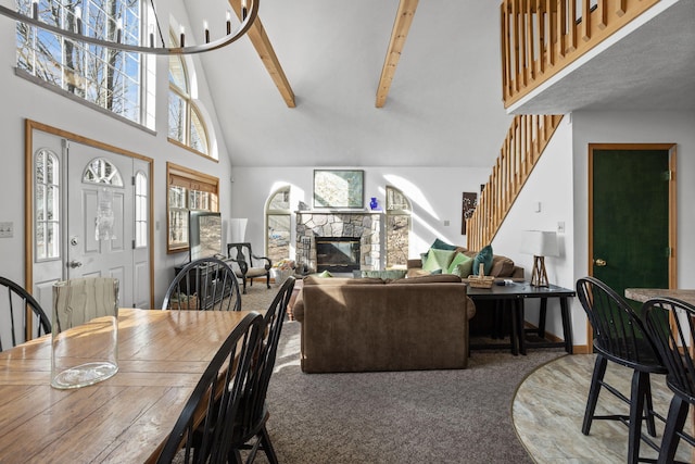 225 N Arrow Dr, Pocono Lake, PA 18347 - carpeted dining space featuring high vaulted ceiling, beam ceiling, a fireplace, and stairs