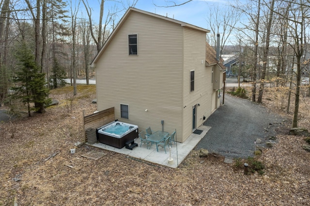 225 N Arrow Dr, Pocono Lake, PA 18347 - view of side of home with a hot tub and a patio area