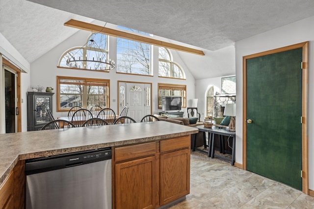225 N Arrow Dr, Pocono Lake, PA 18347 - kitchen with stainless steel dishwasher, vaulted ceiling, a textured ceiling, brown cabinetry, and open floor plan