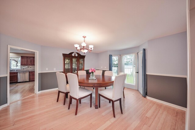 205 Osprey Way E, Stroudsburg, PA 18302 - dining room with a chandelier, light wood finished floors, and baseboards