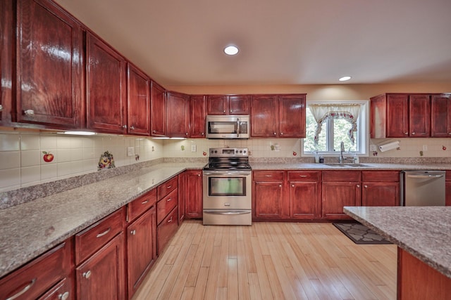 205 Osprey Way E, Stroudsburg, PA 18302 - kitchen featuring appliances with stainless steel finishes, a sink, dark brown cabinets, and recessed lighting