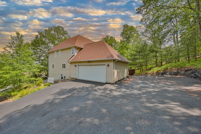 205 Osprey Way E, Stroudsburg, PA 18302 - property exterior at dusk featuring asphalt driveway and an attached garage
