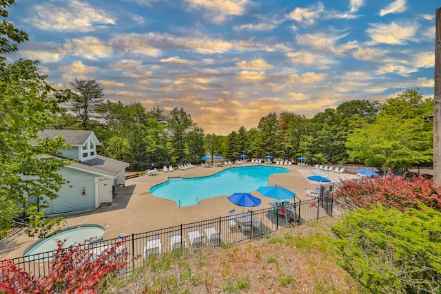 205 Osprey Way E, Stroudsburg, PA 18302 - pool at dusk with a patio, a community pool, and view of scattered trees
