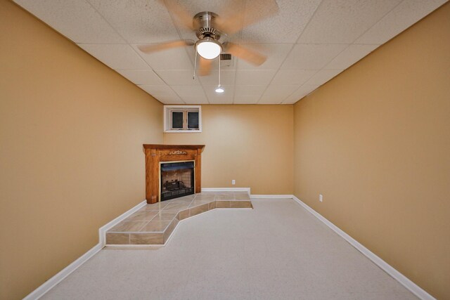 205 Osprey Way E, Stroudsburg, PA 18302 - unfurnished living room with carpet floors, a ceiling fan, a fireplace, a paneled ceiling, and baseboards
