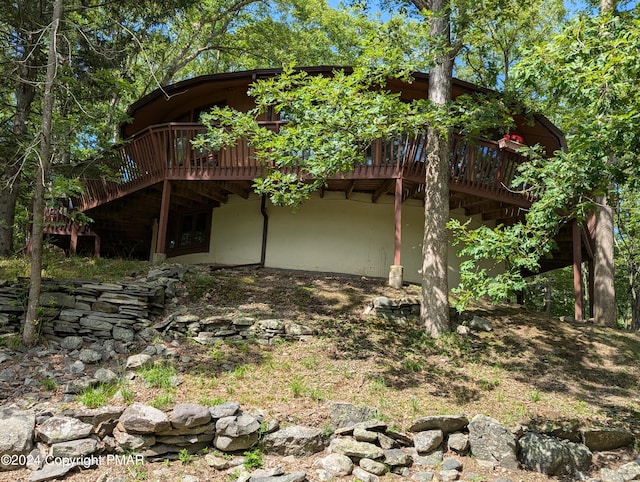 back of property with a wooden deck