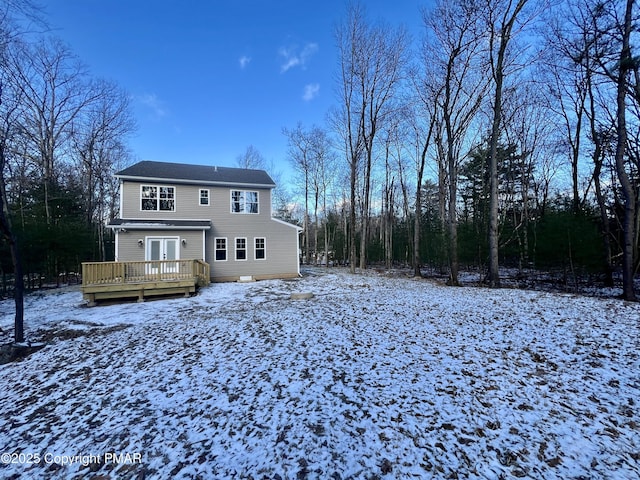 snow covered property featuring a deck