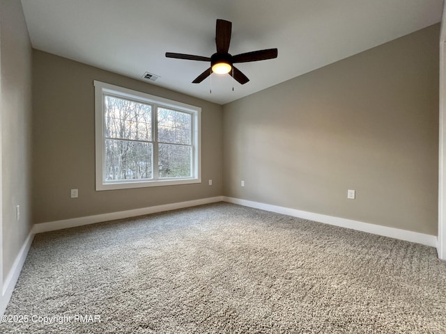 spare room with a ceiling fan, carpet, visible vents, and baseboards