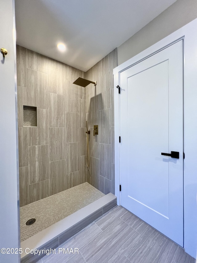 full bath with tiled shower