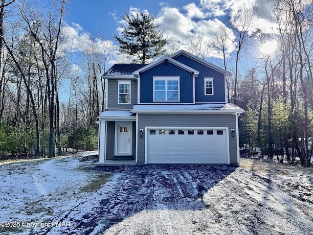 view of front of home with a garage, board and batten siding, and aphalt driveway