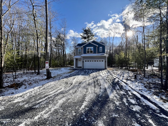 view of snowy exterior with a garage, driveway, and board and batten siding