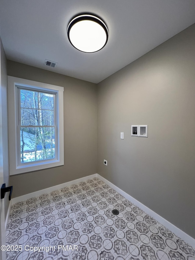 laundry area featuring hookup for a washing machine, laundry area, visible vents, and baseboards