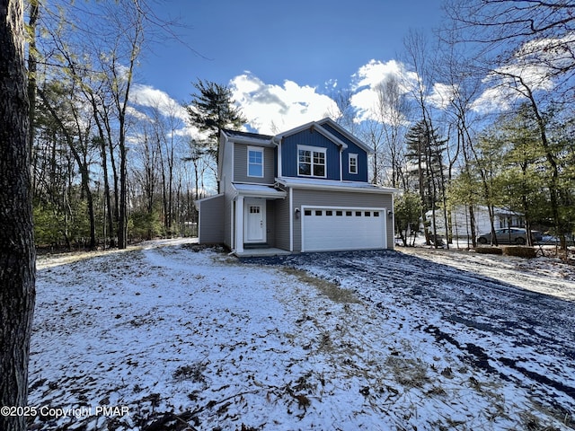 view of front facade featuring driveway, board and batten siding, and an attached garage