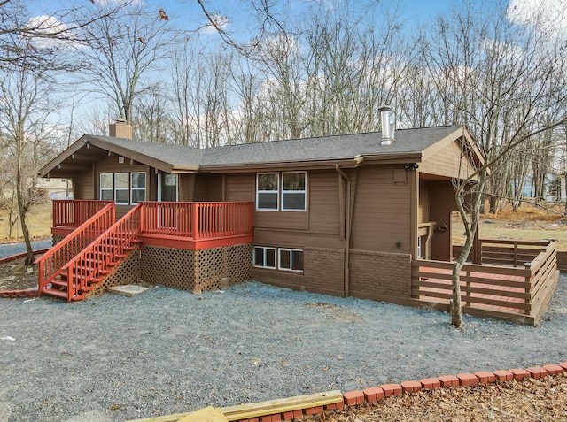 2161 Bushkill Cir, Bushkill, PA 18324 - rear view of house with a chimney, a wooden deck, a shingled roof, fence, and brick siding