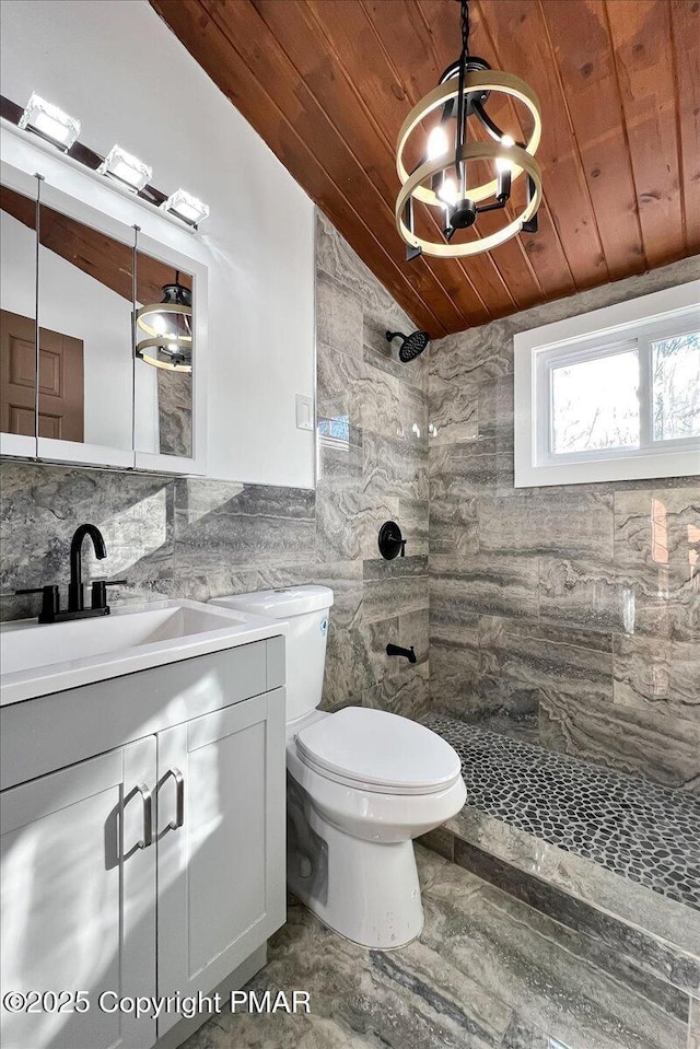 2161 Bushkill Cir, Bushkill, PA 18324 - full bath with wooden ceiling, a tile shower, vanity, tile walls, and toilet