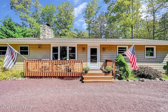 ranch-style home featuring a chimney