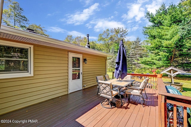 wooden deck featuring outdoor dining area