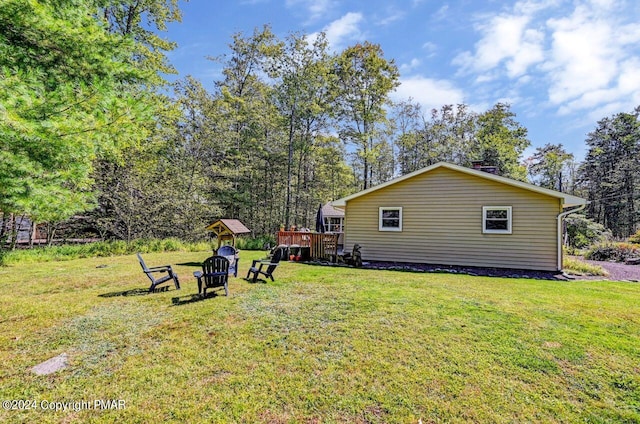 view of yard with a fire pit and a wooden deck