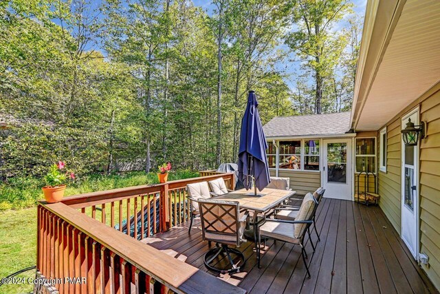 wooden deck featuring outdoor dining space