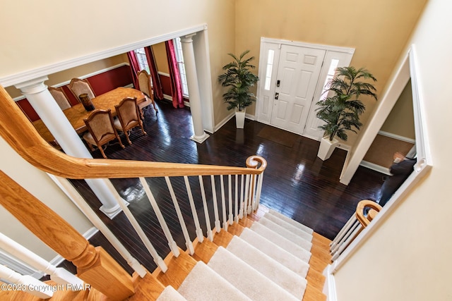 foyer entrance featuring baseboards, stairway, and hardwood / wood-style floors