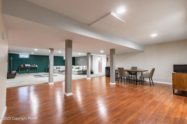 below grade area featuring baseboards, wood finished floors, and recessed lighting