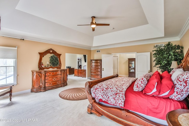 bedroom featuring ornamental molding, carpet flooring, a raised ceiling, and visible vents