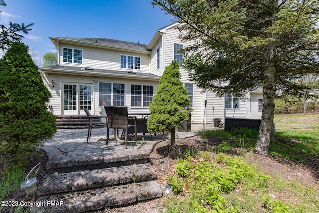 rear view of house with entry steps and a patio area