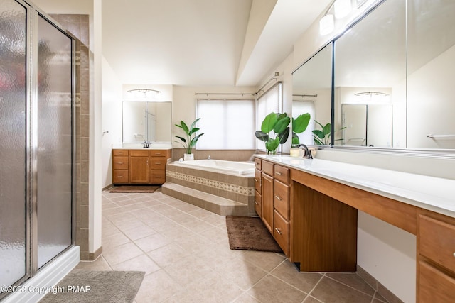 bathroom featuring a stall shower, vanity, a garden tub, and tile patterned floors