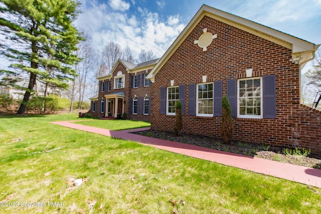 view of front facade featuring a front lawn and brick siding