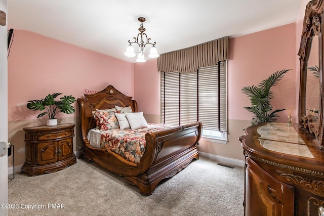 bedroom with baseboards, visible vents, a chandelier, and carpet flooring