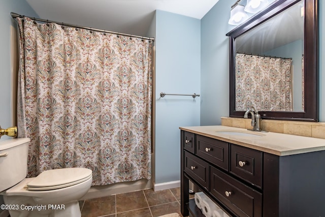 bathroom with toilet, shower / tub combo, vanity, and tile patterned floors