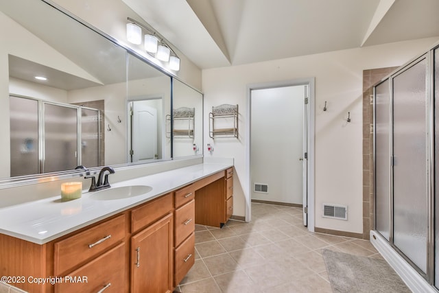 bathroom featuring tile patterned flooring, visible vents, a shower stall, and vanity