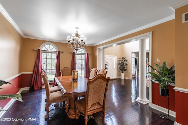 dining space with ornamental molding, wood-type flooring, decorative columns, and baseboards