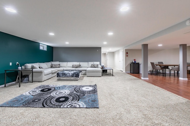 carpeted living room with baseboards, wood finished floors, and recessed lighting