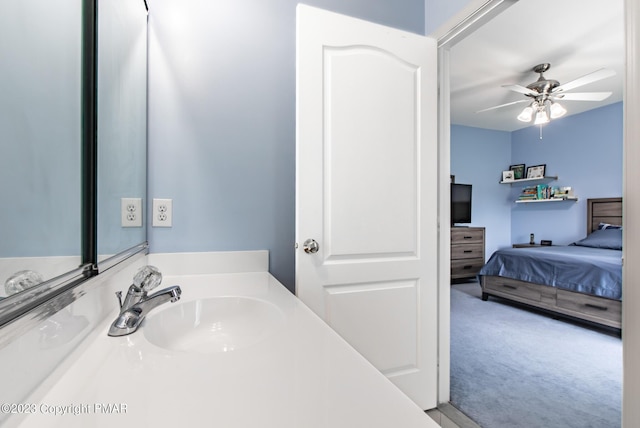 ensuite bathroom featuring a ceiling fan, a sink, and ensuite bathroom