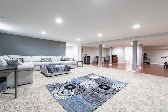 living room featuring carpet floors, recessed lighting, and baseboards