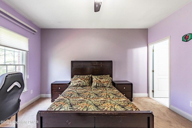 bedroom with carpet floors and baseboards