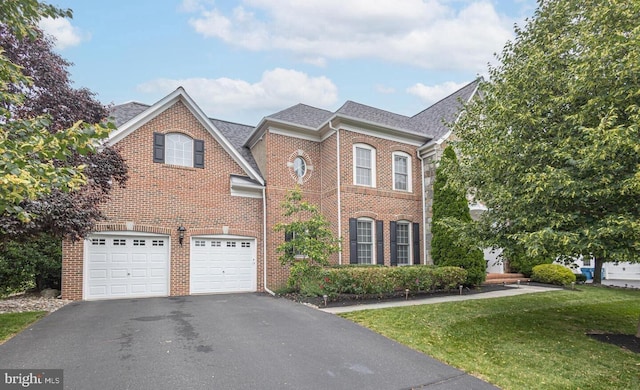405 Hoffman Rd, Harleysville, PA 19438 - view of front of house with asphalt driveway, brick siding, an attached garage, a front lawn, and a shingled roof