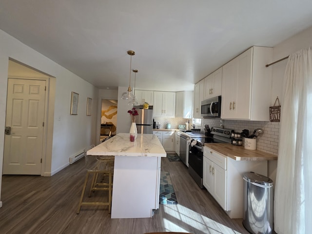 1490 Waterfront Dr, Tobyhanna, PA 18466 - kitchen featuring appliances with stainless steel finishes, backsplash, a center island, white cabinetry, and dark wood-style floors
