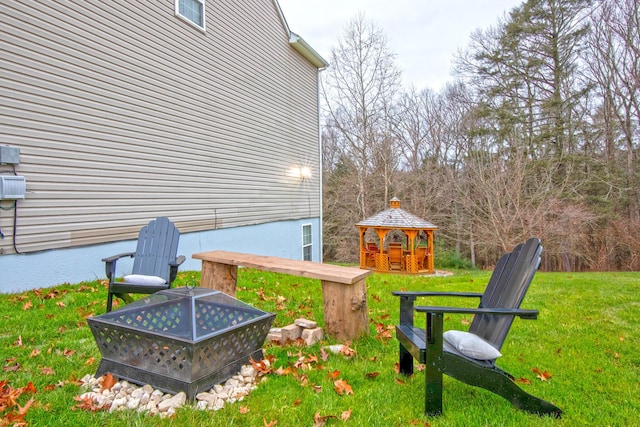 view of yard with a fire pit