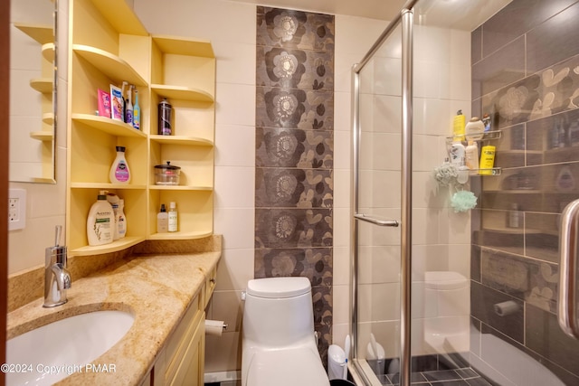 bathroom featuring a stall shower, tile walls, vanity, and toilet