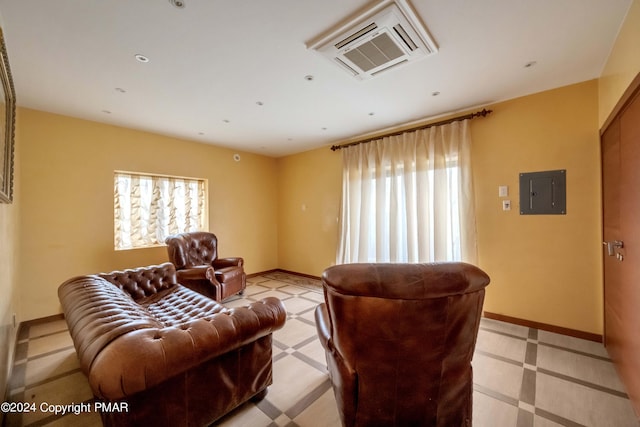 living area with plenty of natural light, electric panel, and baseboards