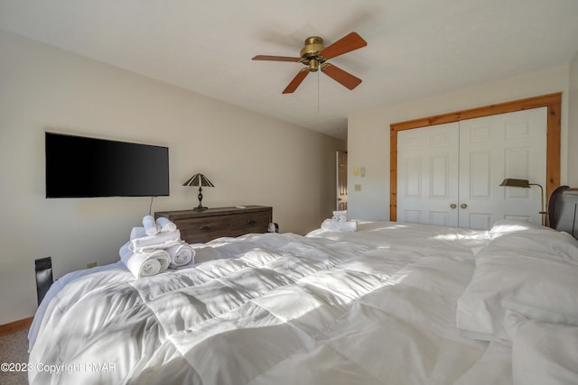 bedroom with a closet, a ceiling fan, and carpet