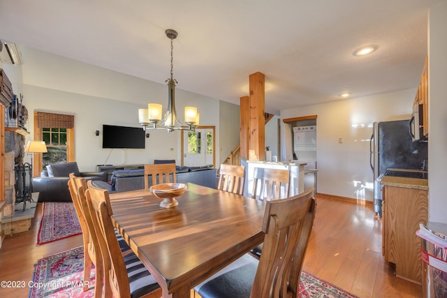 dining area with a chandelier, recessed lighting, light wood finished floors, and baseboards